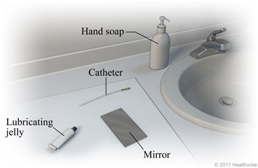 Bathroom sink area, showing supplies of hand soap, catheter, lubricating jelly, and mirror.